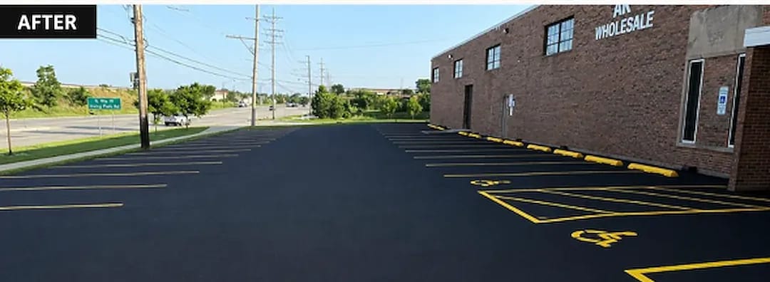 The same parking lot after crack sealing, sealcoating and a full restripe with yellow ADA markings
